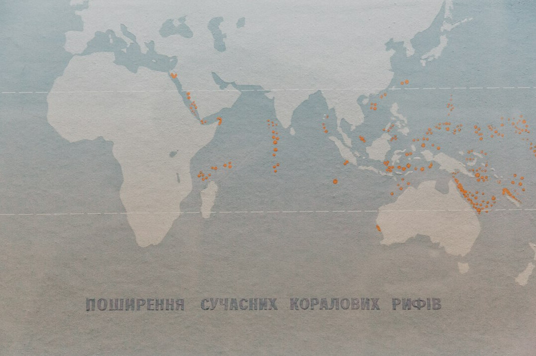 World map on a large screen in a press briefing room