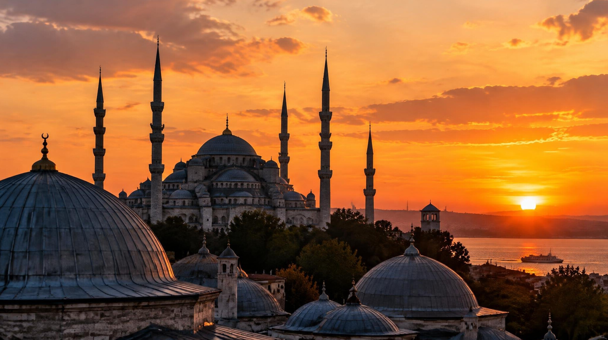 Historic Ottoman-era architecture with domes and minarets at sunset